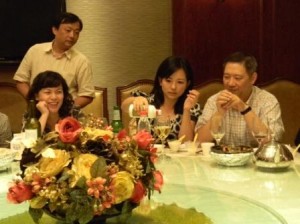 Shanghai trade rep Cici Li pouring Baijiu, the octane distilled spirit, in its small glass which is in a larger beer glass...