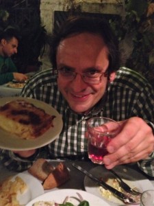 Saganaki cheese (at left) flambéed and flames extinguished with squeeze of fresh lemon juice